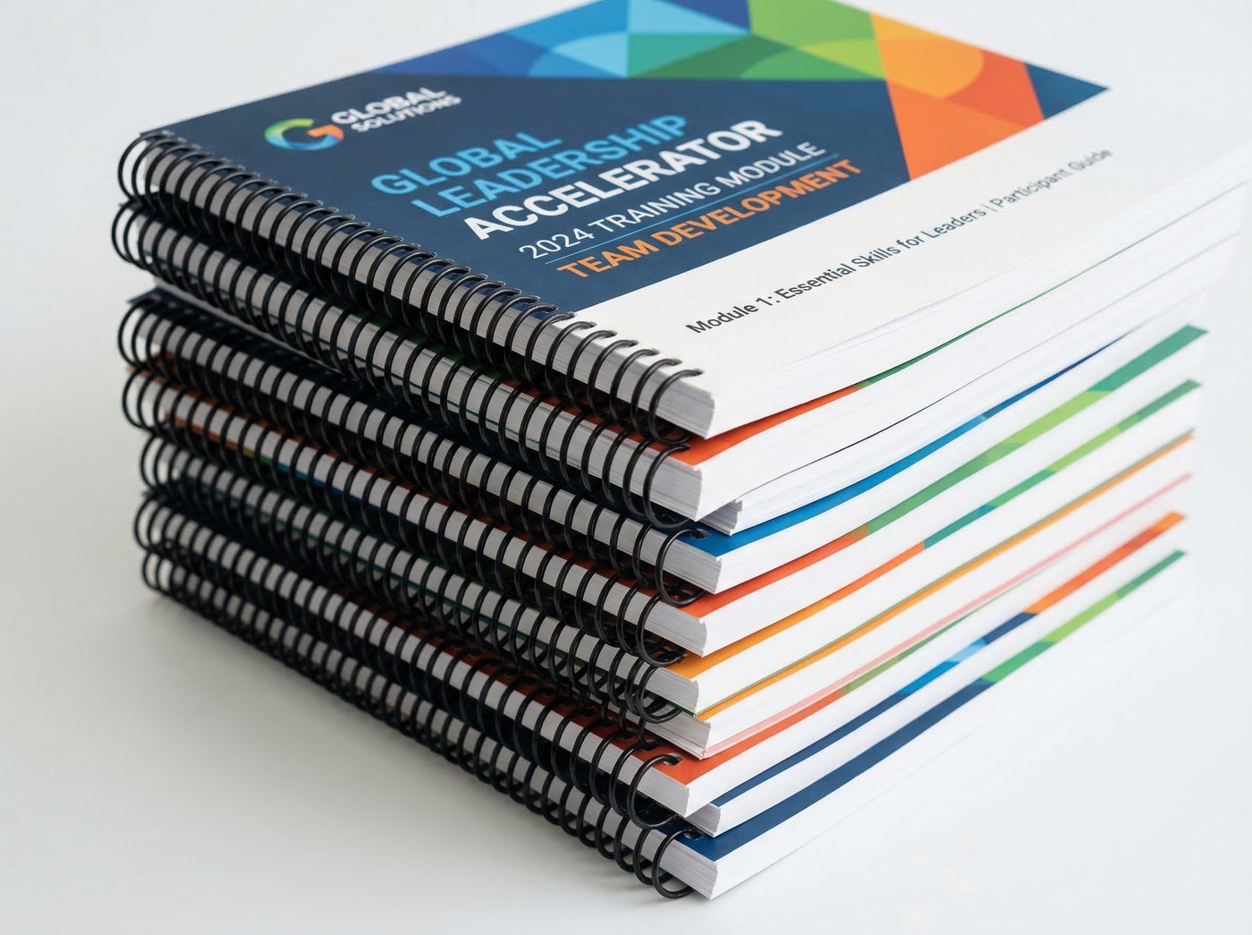 Stack of printed full-color training manuals